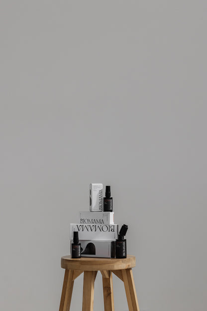 Biomama Skincare essentials reimagined range on display on wooden stool